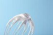 © New Africa - Whisk with whipped cream on light blue background, closeup. Space for text