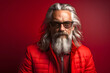 fashionable respectable man with a white beard, glasses and red clothes. portrait of a metrosexual and a successful man