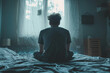 © Denis - Depressed guy suffering from anxiety and panic disorder sitting on bed sad and alone.
