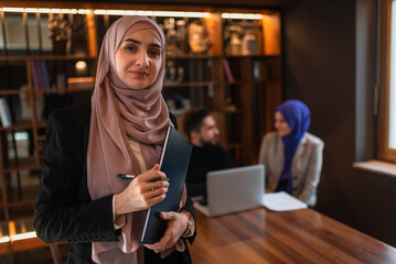 Wall Mural - Portrait of a Muslim business woman front the working team in the office.