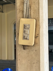 Sticker - A white light switch on an old wooden pole