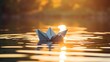 © kept - Image of a paper boat of origami floating on water.