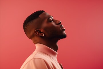 Wall Mural - side view of handsome african american man looking away isolated on red