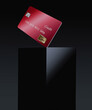 © Rob Goebel - A red credit card or debit card is seen on top of a black box in a 3-d illustration.