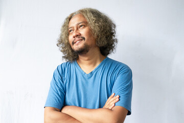 Portrait of happy casual asian man smiling with arms crossed, Young guy standing at white wall, Isolated on white background, copy space.