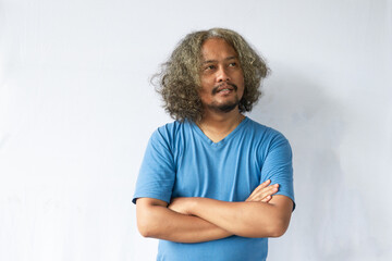 Portrait of happy casual asian man smiling with arms crossed, Young guy standing at white wall, Isolated on white background, copy space.