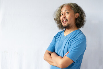 Portrait of happy casual asian man smiling with arms crossed, Young guy standing at white wall, Isolated on white background, copy space.