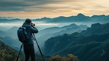 Professional Photographer Taking Picture With Modern Camera In Mountains.