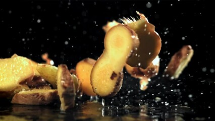 Wall Mural - Pieces of fresh ginger fall on the table. Filmed on a high-speed camera at 1000 fps. High quality FullHD footage