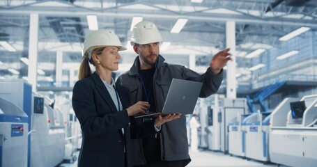 Poster - Experienced Male and Female Engineers Standing on a Platform at a Modern Industrial Factory, Using Laptop Computer and Discussing Production of Modern Electronics for Artificial Intelligence Machines.