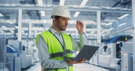 Aufkleber - Portrait Of a Caucasian Male Engineer Standing In Factory Hall, Using Laptop Computer at a Machinery Manufacturing Facility. Specialist Using Online Software to Program Equipment on Production Line.