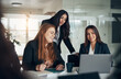 © Flamingo Images - CEO and her team working together at a table in an office boardroom