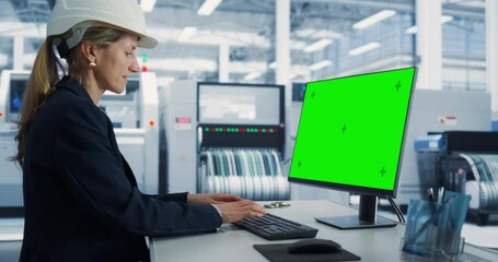 Poster - Female Caucasian Software Developer Working on a Desktop Computer with Green Screen Chromakey On Display At An Electronics Factory. Technological Research and Development Office Monitoring Production.