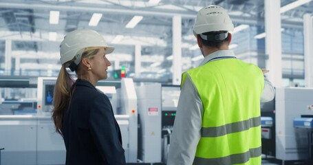 Aufkleber - Caucasian Male Process Engineer and Female Quality Control Technician Standing In Factory Hall And Talking. Professionals Discussing Production at Modern Machinery Manufacturing Plant, New Projects.