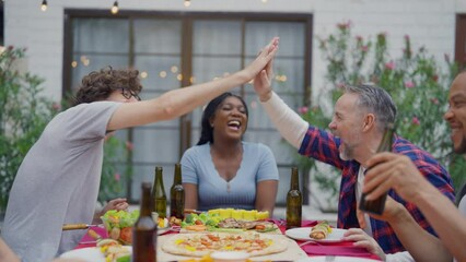 Wall Mural - Multi-ethnic family having fun, enjoy party outdoors in the garden. 