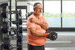 © Ljupco Smokovski - Mature man lifting weights at a gym and suffering from pain in shoulder