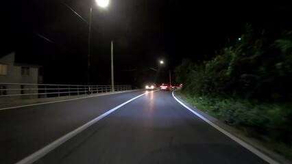 Wall Mural - driving a car on countryside road at night with adaptive matrix headlights