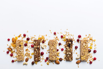 Wall Mural - Various granola bars on table background. Cereal granola bars. Superfood breakfast bars with oats, nuts and berries, close up. Superfood concept