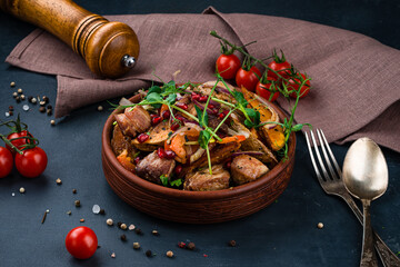 Canvas Print - Georgian cuisine pork pieces with potato wedges, onions, sweet peppers, tomatoes, pomegranate seeds and herbs.