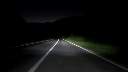 Wall Mural - driving a car on countryside road at night with adaptive matrix headlights