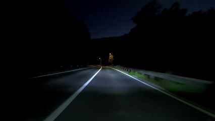 Wall Mural - driving a car on countryside road at night with adaptive matrix headlights