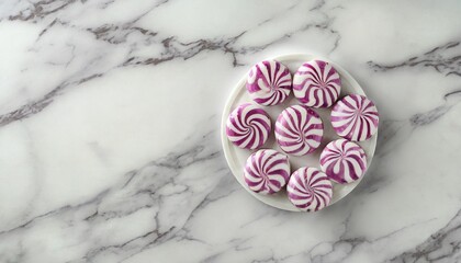 Poster - round peppermint candies on white marble surface