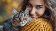 © Amonthep - young woman holding cute cat with green eyes. Female hugging her cute long hair kitty. Background