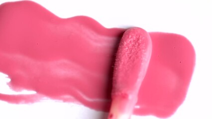 Poster - Cosmetic liquid lip gloss, lipstick smudge, smear, stroke. Smears of lip gloss applicator on a white background. Advertising cosmetics.