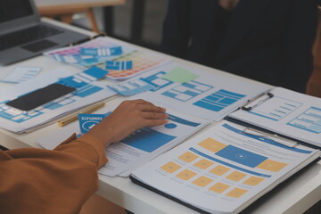 Close up ux developer and ui designer use augmented reality brainstorming about mobile app interface wireframe design on desk at modern office.Creative digital development agency