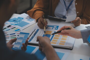 Close up ux developer and ui designer use augmented reality brainstorming about mobile app interface wireframe design on desk at modern office.Creative digital development agency