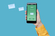 © New Africa - Got new message. Woman holding smartphone on light blue background, closeup