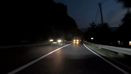 Wall Mural - driving a car on countryside road at night with adaptive matrix headlights