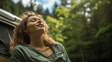Young Woman With Eyes Closed Breathing Fresh Air While Camping In Woods