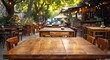 Elegant wooden table in restaurant with blurred bokeh background. Vintage cafe ambiance with cozy interior design. Abstract business setting in pub with retro decoration perfect for dining