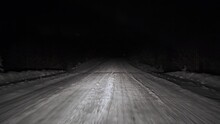 Driving On Snow Road In Forest At Night. POV