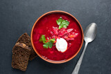 Fototapeta Desenie - Red beet vegetarian soup Borscht served with sour cream in ceramic bowl, table top view