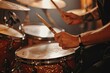Close up of a drummer s hands rhythmically hitting drums at a studio