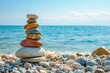 Life balance harmony and meditation symbolized by a colorful pebble pyramid on a beach near the sea