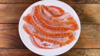 Wall Mural - Salted slices of salmon bellies on dish on rustic table