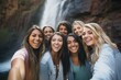 friends taking group selfie, waterfall in the backdrop