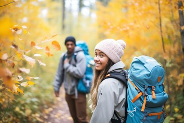 Wall Mural - teens hiking with backpacks in a forest