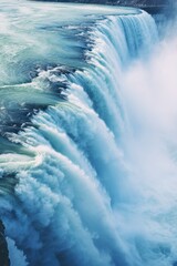 Poster - A stunning image capturing the beauty of a large waterfall with water pouring over it. Perfect for nature lovers and travel enthusiasts.