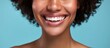 A woman with a smile showcasing oral hygiene and health in a studio portrait.