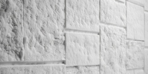 Poster - A black and white photo of a snow covered wall. Suitable for various uses