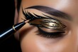 Closeup of a model's eye adorned with elaborate black and gold eyeliner art, accented with teal dots