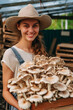 Woman Farmer holding box with mushrooms