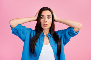 Wall Mural - Portrait of astonished speechless woman with long hairstyle wear stylish shirt hold arms on head staring isolated on pink color background