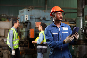 portrait worker or engineer working on tablet in the factory