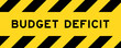 Yellow and black color with line striped label banner with word budget deficit
