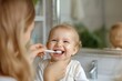 © Straxer - Personal hygiene, mom teaching her child. Sustainable parenting. Baby laughing and happy to clean teeth. Morning ritual. Harmony in family, happy motherhood.